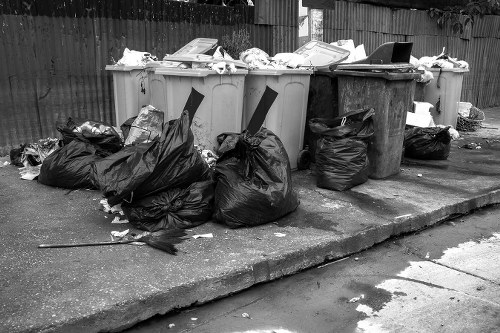 Professional team clearing out a cluttered garage in Willesden